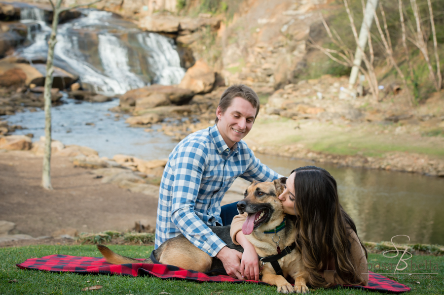 A happy dog and equally happy couple curl up on a blanket...see Reedy Falls in the background.